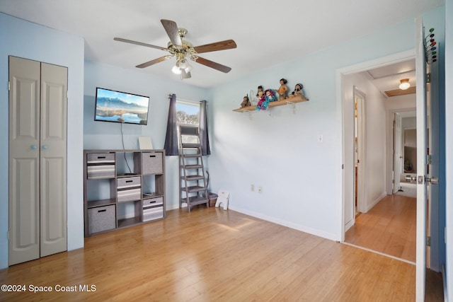 living room with wood-type flooring and ceiling fan