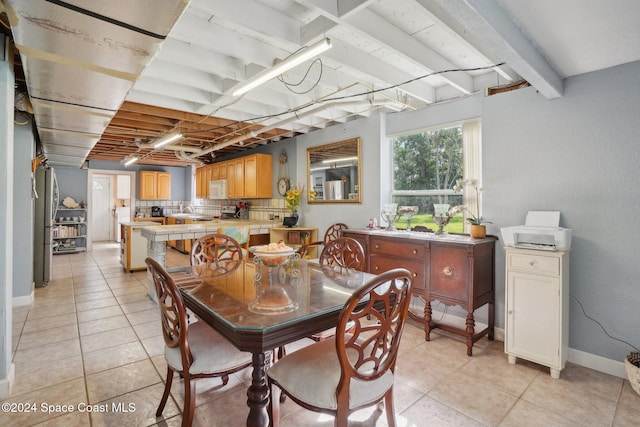 tiled dining area with beam ceiling