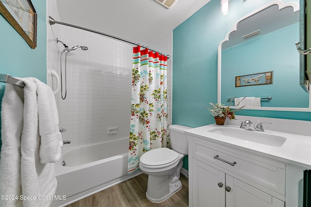 full bath featuring toilet, wood finished floors, vanity, visible vents, and shower / tub combo with curtain