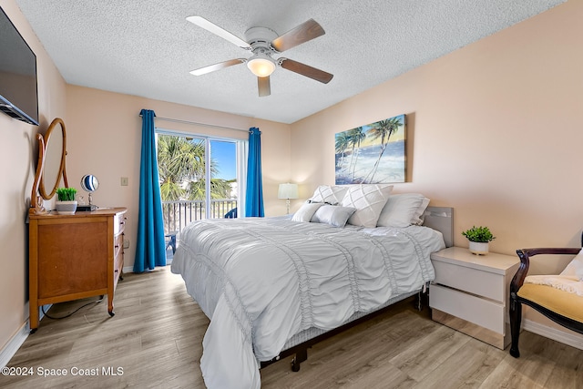 bedroom with light wood finished floors, access to outside, a ceiling fan, and a textured ceiling