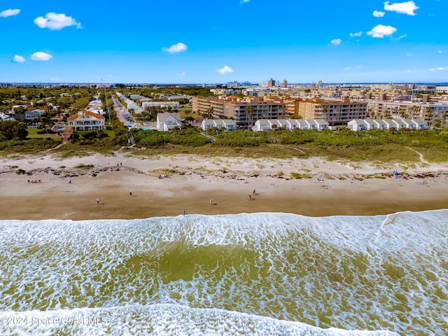 birds eye view of property featuring a view of the beach and a water view