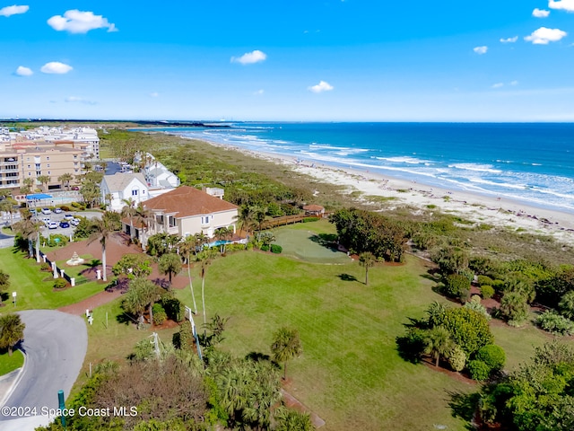 bird's eye view with a water view and a beach view