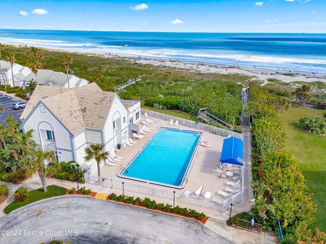 drone / aerial view with a water view and a view of the beach