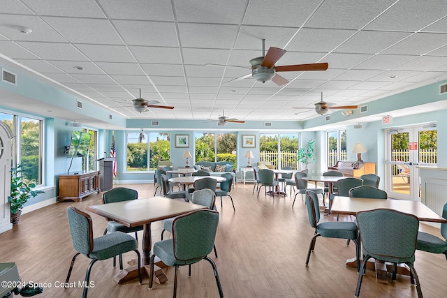 sunroom / solarium with a paneled ceiling, visible vents, and french doors