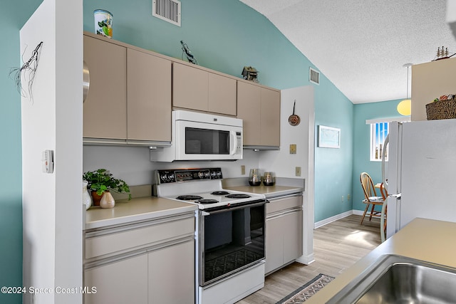 kitchen with white appliances, visible vents, light countertops, and a textured ceiling