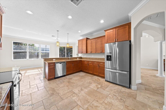 kitchen with sink, hanging light fixtures, ornamental molding, appliances with stainless steel finishes, and kitchen peninsula