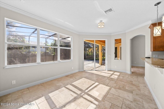 interior space featuring a textured ceiling and crown molding