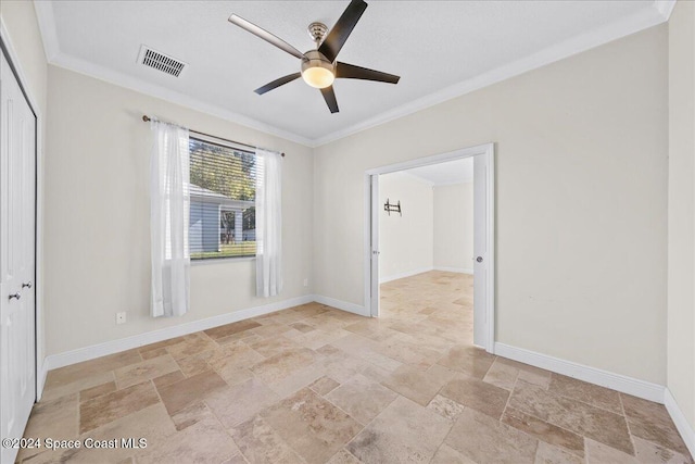 empty room with crown molding and ceiling fan