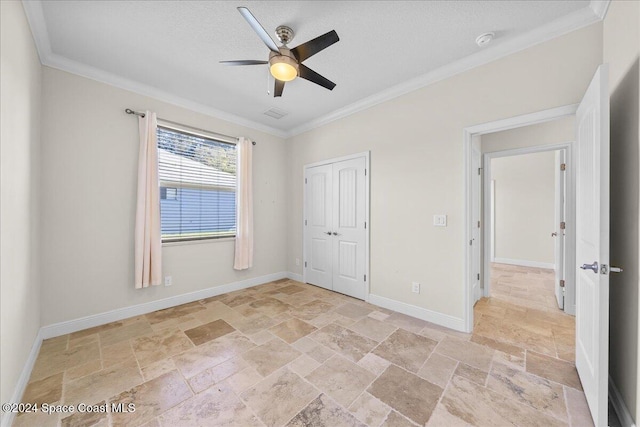 unfurnished bedroom featuring ceiling fan, ornamental molding, and a closet