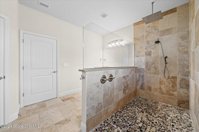 bathroom with tiled shower