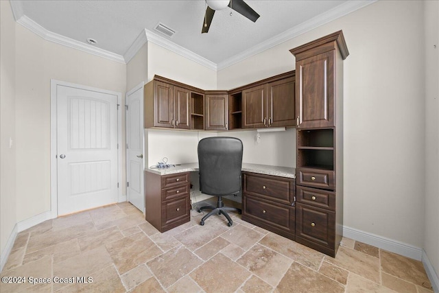 home office with built in desk, ceiling fan, and ornamental molding