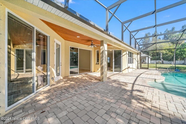 exterior space featuring ceiling fan and a swimming pool