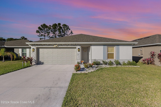 ranch-style house with a yard and a garage