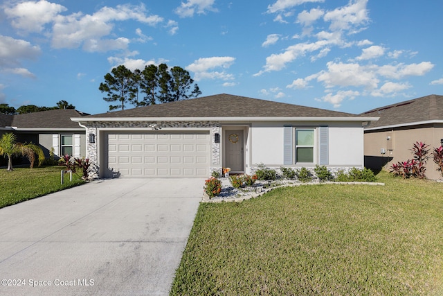 ranch-style house featuring a front yard and a garage