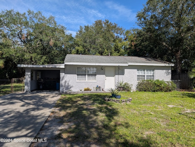 ranch-style home with a front yard and a carport