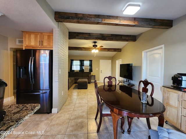 tiled dining space featuring beamed ceiling and ceiling fan