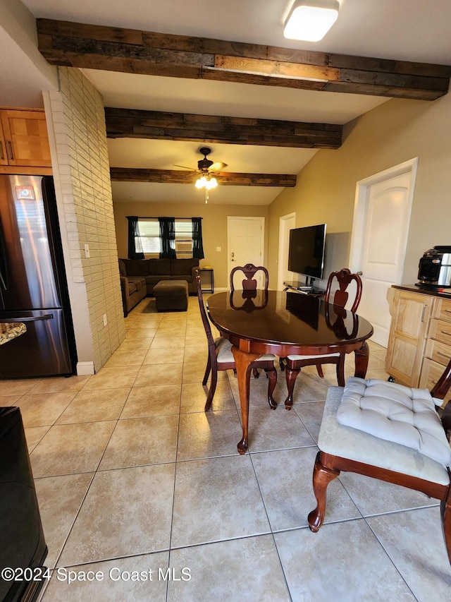 tiled dining room featuring beamed ceiling and ceiling fan