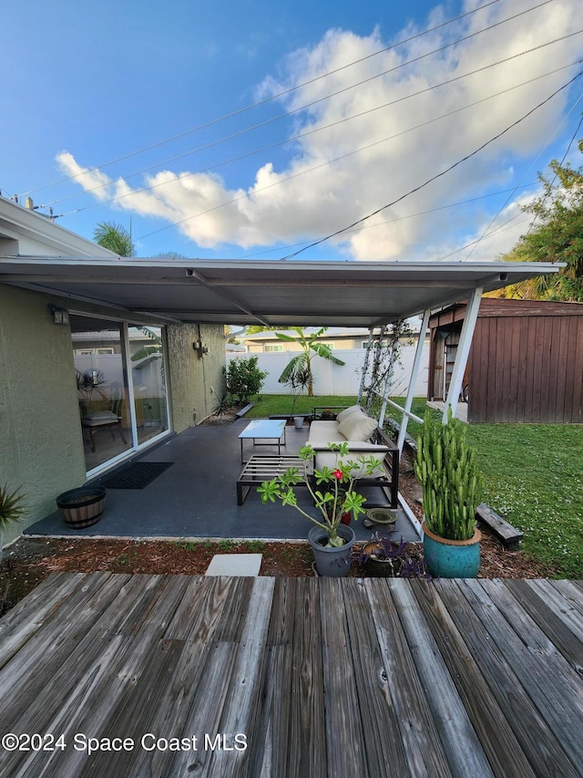 wooden deck with a yard, a patio, and an outdoor hangout area