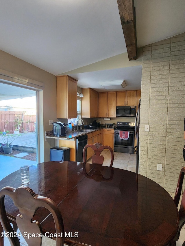 dining area featuring light tile patterned flooring and sink