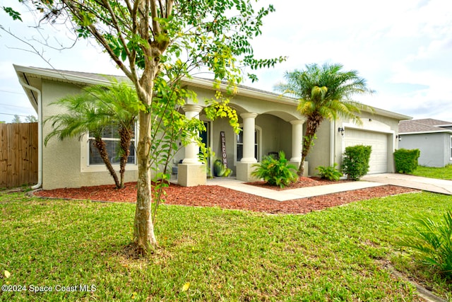 ranch-style home featuring a garage and a front yard