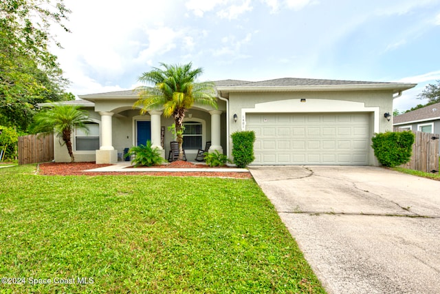 view of front of home with a garage and a front yard