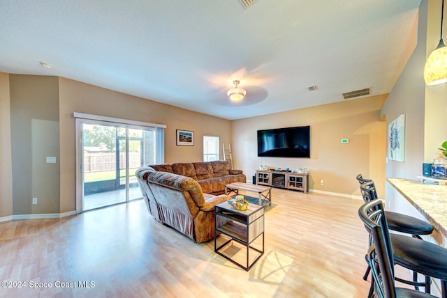 living room featuring ceiling fan and light hardwood / wood-style floors