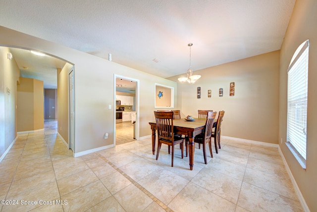 dining room featuring plenty of natural light, a chandelier, and light tile patterned flooring