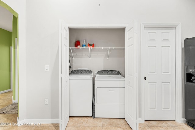 laundry area featuring light tile patterned floors and washing machine and clothes dryer