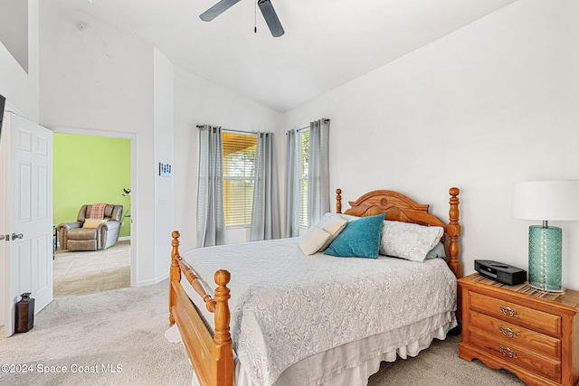 carpeted bedroom featuring ceiling fan and vaulted ceiling