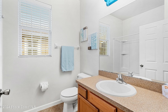 bathroom with a shower, vanity, toilet, and tile patterned flooring