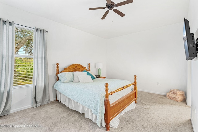 carpeted bedroom with multiple windows and ceiling fan