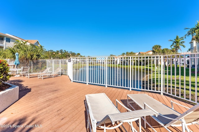 wooden terrace featuring a water view