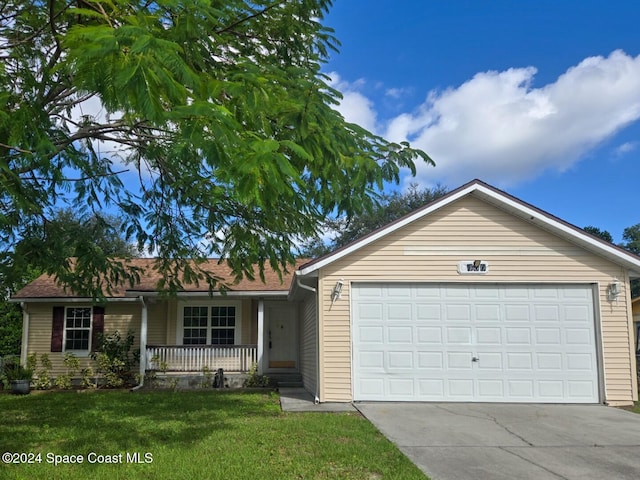 ranch-style home with a garage, a front yard, and covered porch