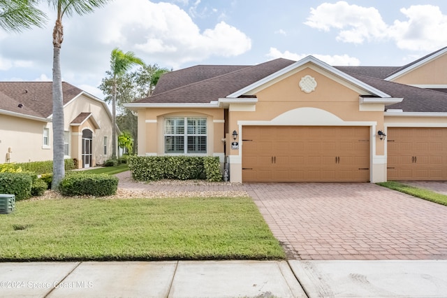 view of front facade featuring a front yard and a garage