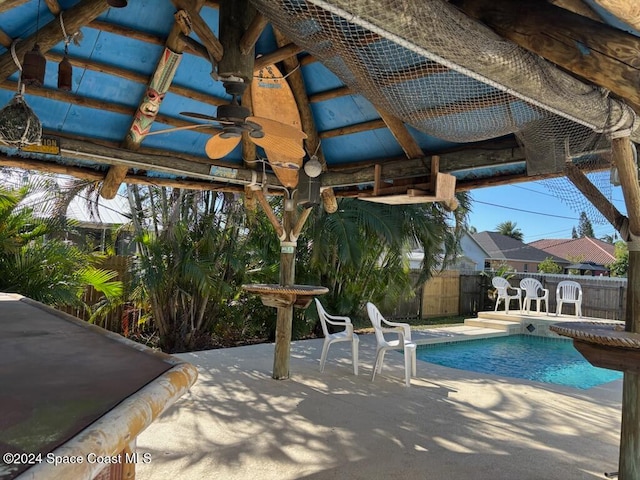 view of swimming pool with ceiling fan, a pergola, and a patio