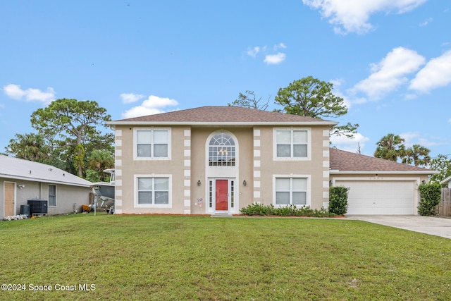 view of front of property featuring a garage and a front lawn