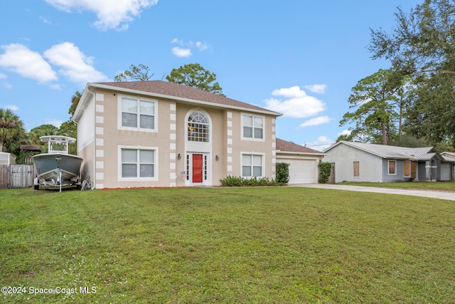 view of front of house featuring a garage and a front lawn