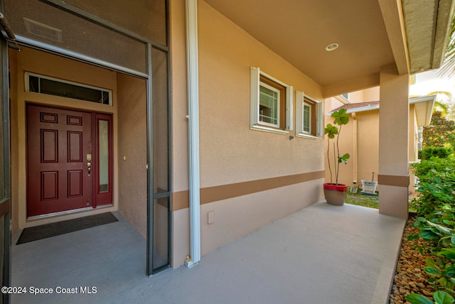 view of exterior entry with covered porch