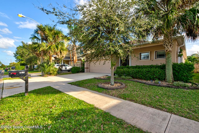 view of front of house with a garage and a front yard