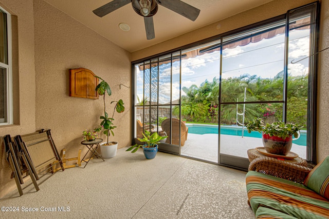 sunroom / solarium with lofted ceiling and ceiling fan