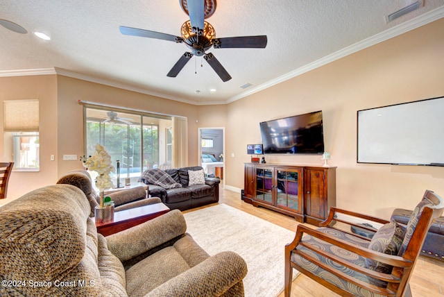 living room with crown molding, ceiling fan, a textured ceiling, and light hardwood / wood-style floors