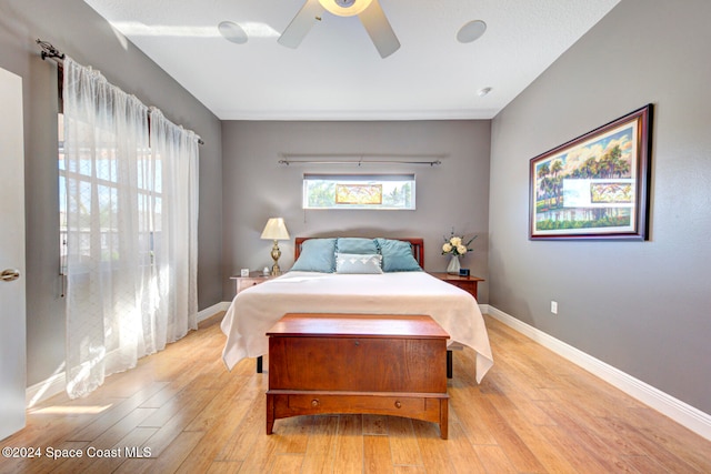 bedroom with ceiling fan and light wood-type flooring