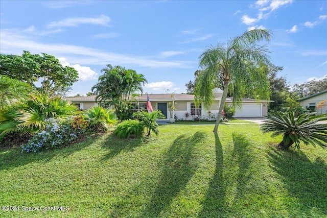 single story home featuring a front lawn and a garage