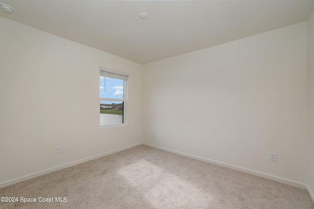 empty room featuring light colored carpet