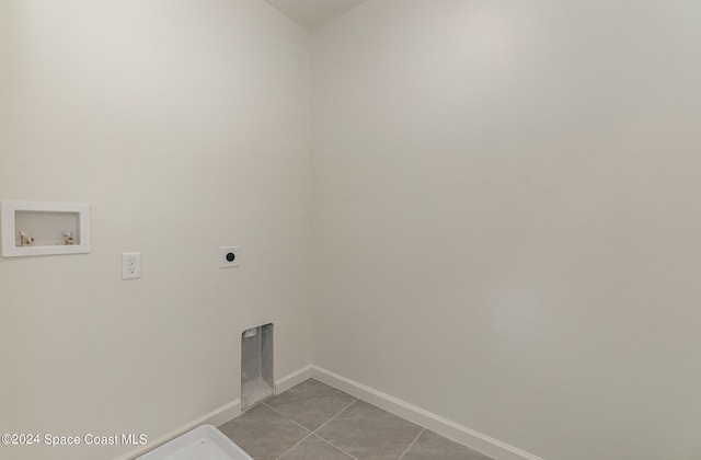 clothes washing area featuring washer hookup, electric dryer hookup, and light tile patterned flooring