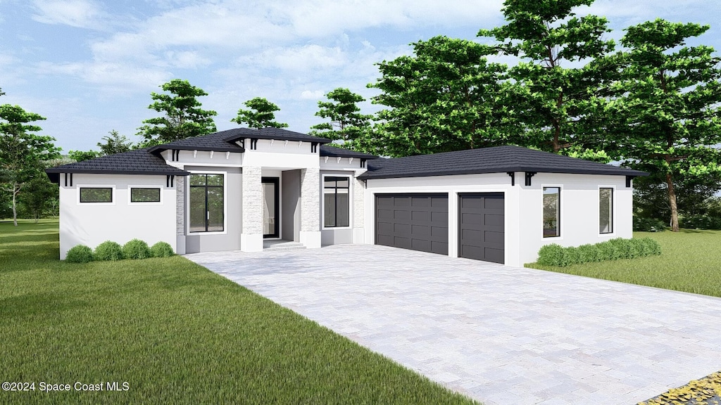 view of front of home featuring a front yard and a garage