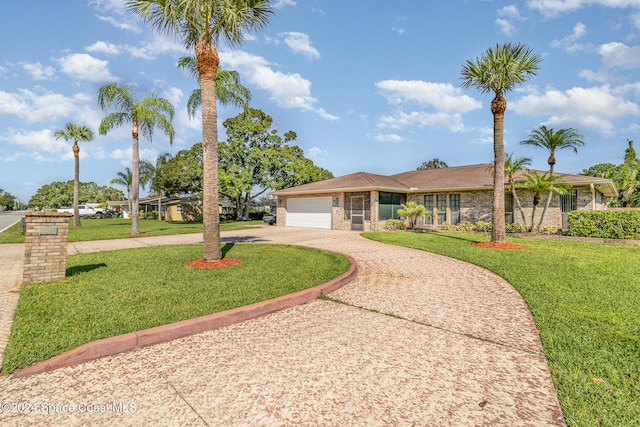 ranch-style house featuring a front yard and a garage