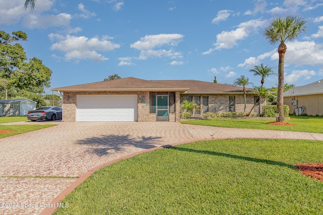 single story home with a front yard and a garage