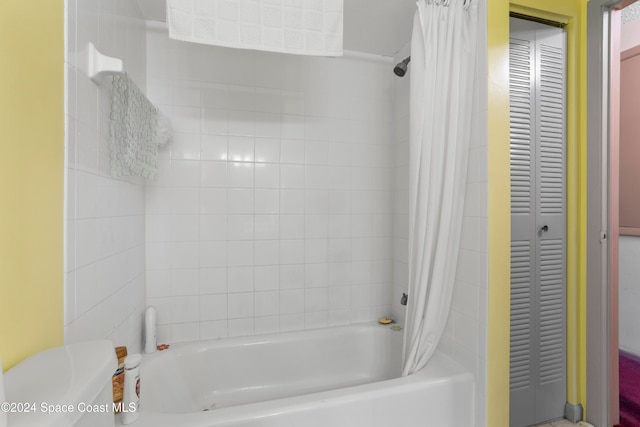 bathroom featuring shower / bath combo and toilet