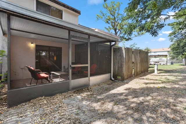 rear view of house with a sunroom